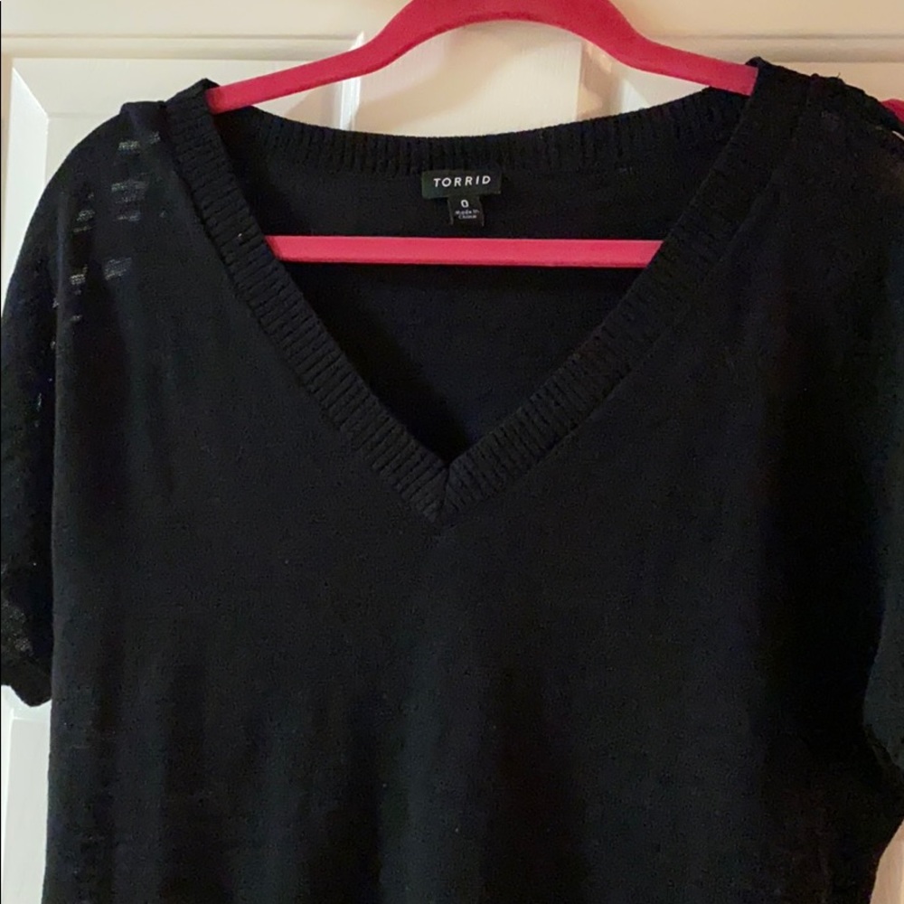 Black sweater with criss cross pattern on the arms
